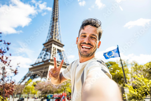 Happy tourist taking selfie picture in front of Eiffel Tower in Paris, France - Travel and summer vacation life style concept