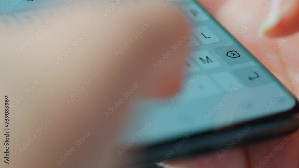 Female hands typing text on smartphone close-up.