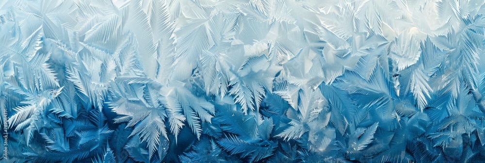 Subtle shades of blue and white highlight the delicate ice crystal formations on a frosty winter window creating an abstract pattern Subtle shades of blue and white highlight the delicate ice crystal formations on a frosty winter window creating an abstract pattern