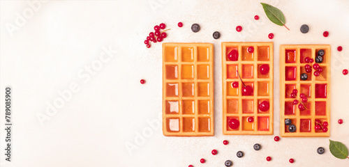 Waffles with berries and syrup. On a white background. cope space