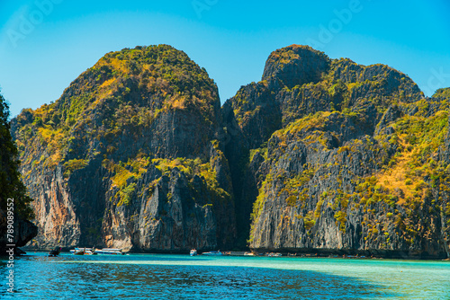 Beautiful natural view of Maya Bay during the day. Popular tourist destination on Phi-phi Island, Thailand during high season with clear sea water, white sand and very iconic high cliffs
