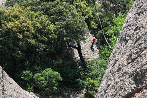 climber climbs to the top, rocks around Montserrat monastery, near Barcelona, Catalonia, Spain