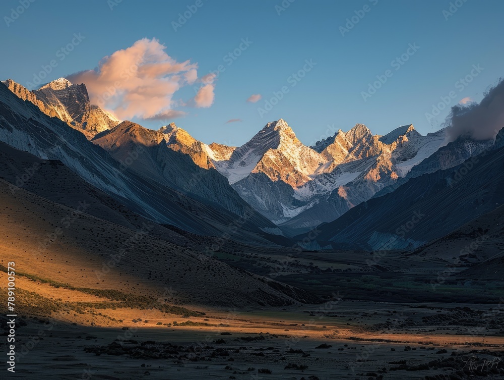 Twilight Majesty: Mountains Cast Shadows Across Tranquil Valley