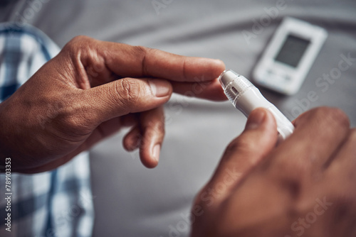 Person, hand and blood sugar with finger in home for diabetes to monitor insulin, glucometer or test. Medical, pen and safety or health measure as genetic problem or bad diet, wellness or diagnostic photo