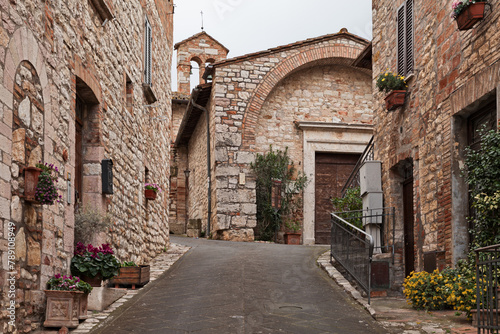 Corciano  Perugia  Umbria  Italy  narrow alley and the ancient Church of San Cristoforo  now home to a museum  in the old town of the picturesque village