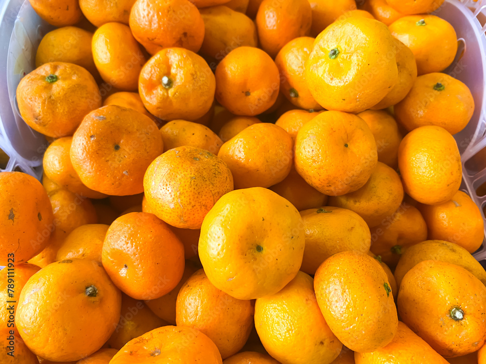oranges in a plastic container in a fruit shop oranges in a plastic container in a fruit shop