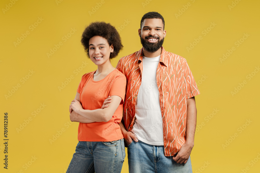 Happy African American ethnicity couple wearing casual clothes, looking at camera Happy African American ethnicity couple wearing casual clothes, looking at camera