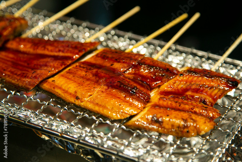 Smoked japanese eel in a market stall in Nishiki fish market in Kyoto, Japan.