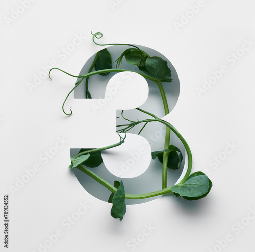 The number three is made from young pea shoots on a white background.