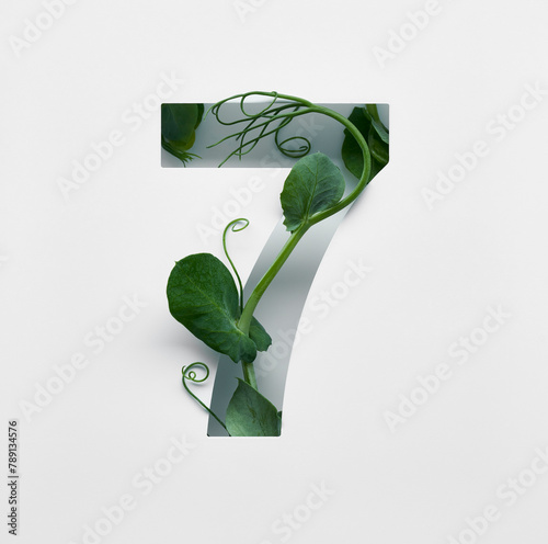 The number seven is made from young pea shoots on a white background.