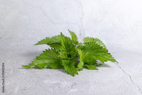 A bunch of fresh nettles on the table.