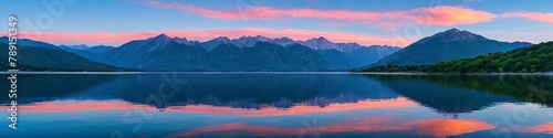 Majestic peaks reflected in a calm lake at sunset. Dawn in the mountains. Panoramic view of the beautiful mountain landscape. photo