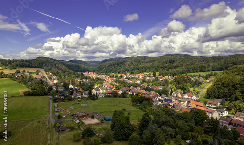 Aer ial view of a German village surrounded by meadows, farmland and forest. Germany. photo