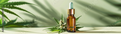 Still life of cannabis leaves and buds with a dropper bottle of CBD oil on a white table against a green background., banner