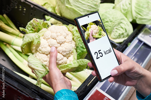Checking calories on cauliflower vegetable with smartphone