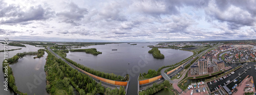 Panorama 180 degrees of Veluwemeer aerial seen from Harderwijk recreational port with highway passing in the foreground photo