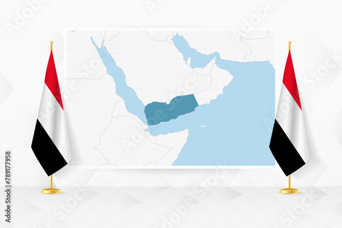 Map of Yemen and flags of Yemen on flag stand.