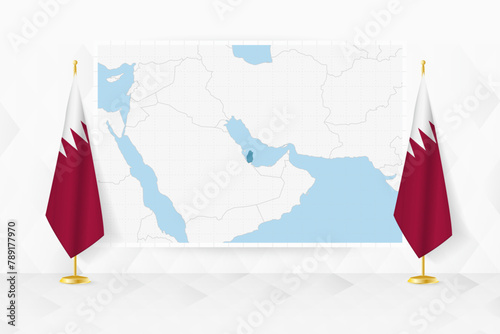 Map of Qatar and flags of Qatar on flag stand.
