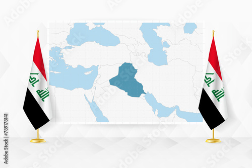 Map of Iraq and flags of Iraq on flag stand.