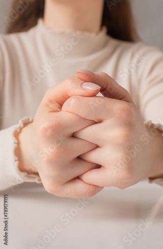 close up of a person holding a finger on their hands