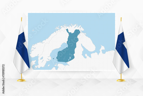 Map of Finland and flags of Finland on flag stand.