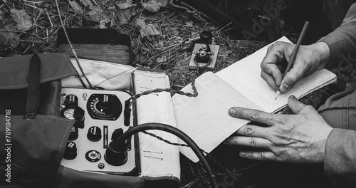 Obraz na płótnie Russian Soviet Infantry Red Army Soldier In World War II using Russian Soviet Portable Radio Transceiver In Trench Entrenchment In Spring Autumn Forest. . Headphones And Telegraph Key. Close Up Hands, w salonie