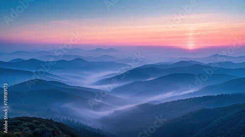 The Sun Setting Over Foggy Mountains