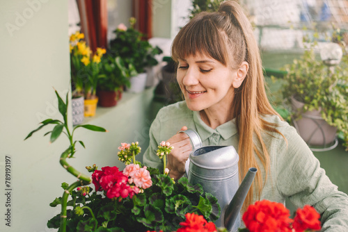 Woman Gardener Watering Plants at City Balcony (ID: 789193197)