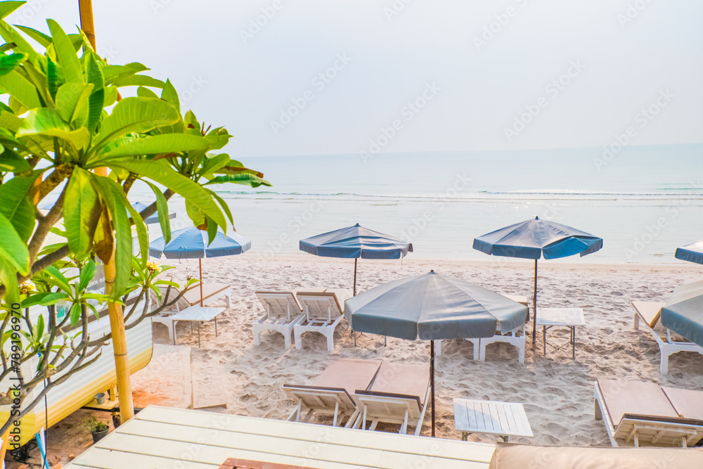 Rows of sun loungers and umbrellas on sandy beach in Tropical Beach,vacation concept.