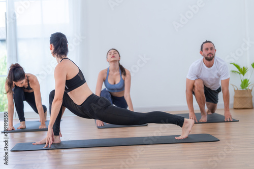 Active woman engages in a backbend yoga pose  demonstrating grace and athletic skill on her mat