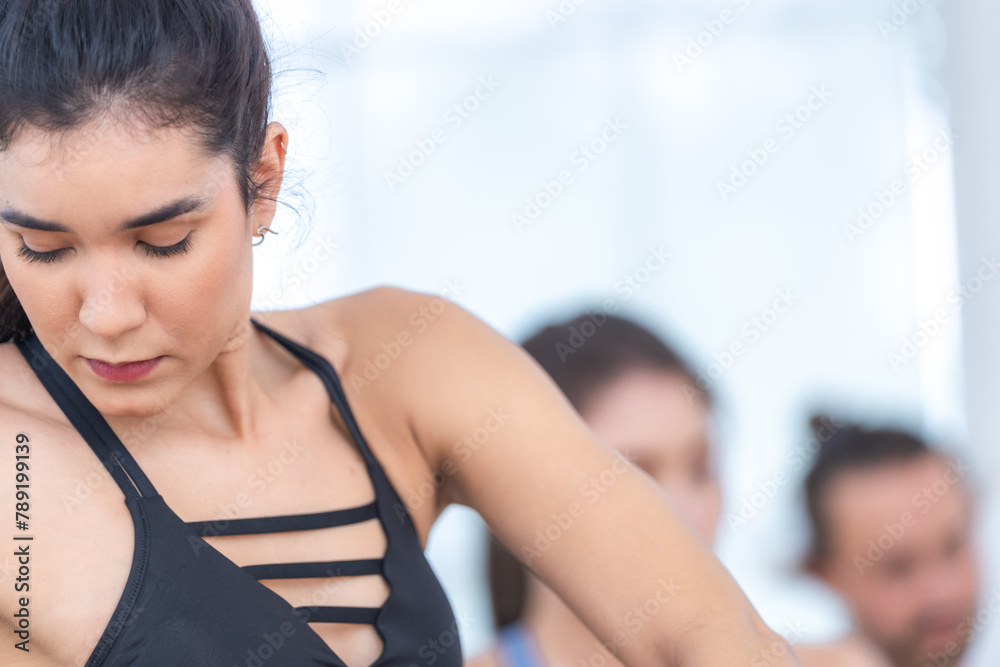 Confident yoga participant performs a balance-focused pose during a class, exuding strength and determination. Confident yoga participant performs a balance-focused pose during a class, exuding strength and determination.