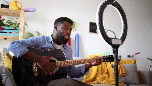 preparing online guitar course african american man explaining how to play guitar