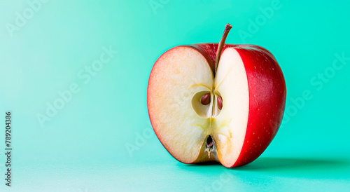 Half a red apple on a blue background