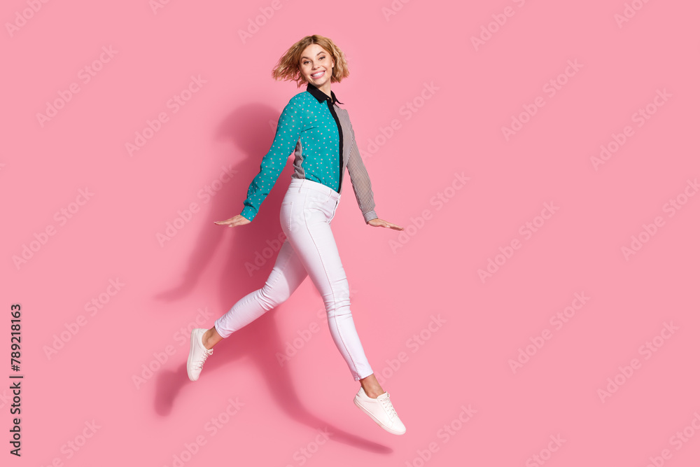 Full size photo of pretty young girl running shopping model wear trendy striped cyan outfit isolated on pink color background Full size photo of pretty young girl running shopping model wear trendy striped cyan outfit isolated on pink color background