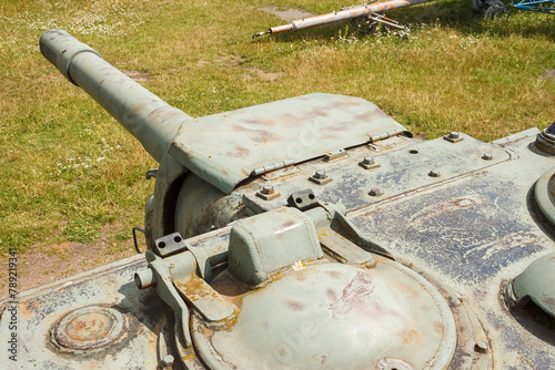 Fragment  tower and barrel of heavy self-propelled artillery ISU-152. Design elements and details of the old Soviet tank. Military green camouflage metal background