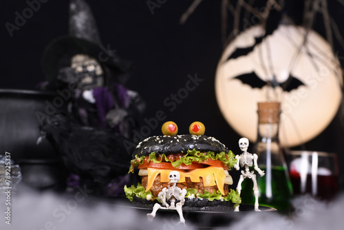  Monster Burger. Black bun, juicy beef cutlet, lettuce, onion, tomato and cheese in the shape of teeth, in the company of skeletons. Definitely a pick-me-up and a perfect Halloween party appetizer