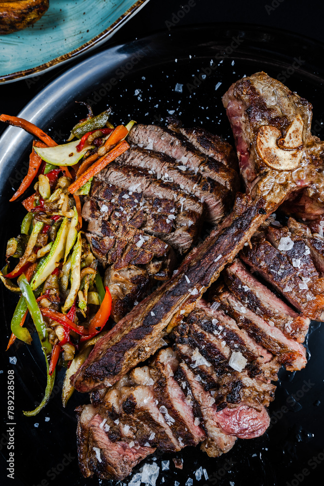 Perfectly cooked Tbone steak with sauteed vegetables Stock Photo