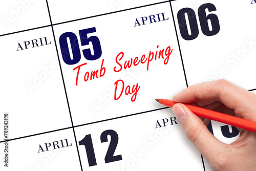 April 5. Hand writing text Tomb Sweeping Day on calendar date. Save the date.