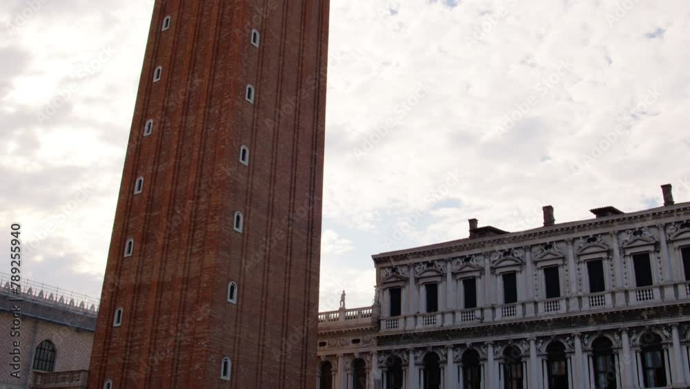 Low-angle view of the famous Campanile di San Marco in Venice, Italy, against a cloudy sky