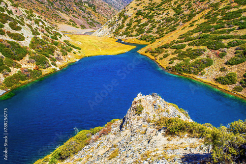 Mountain lake Koksay in the Aksu-Zhabagly Nature Reserve. Lake Koksay located in the Tien Shan mountains in the southern Kazakhstan. Aksu-Zhabagly is the oldest nature reserve in Central Asia photo