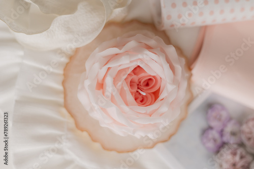 handmade candle in the shape of a flower on a light background  space for text