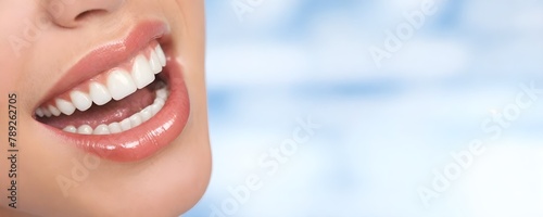 Close-up of a person s mouth slightly open against a blurred blue and white background