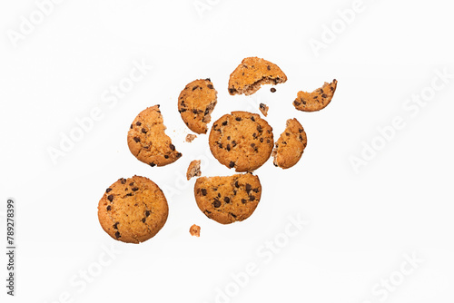 Flying chocolate cookies with slices and crumbs on a white background. Levitation of food