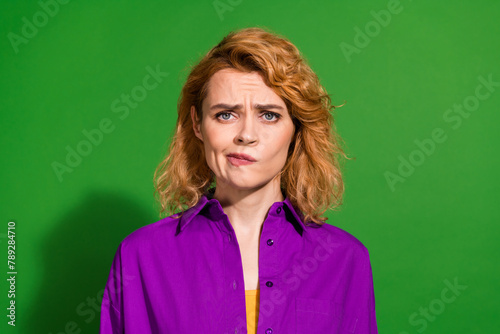 Photo portrait of attractive young girl moody face upset dressed stylish violet garment isolated on green color background © deagreez