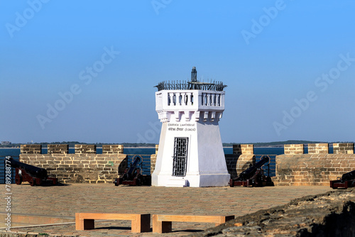 vintage diu fort in gujarat. The old whitewashed Couraca lighthouse inside the ancient, Portuguese built fort in the island of Diu photo