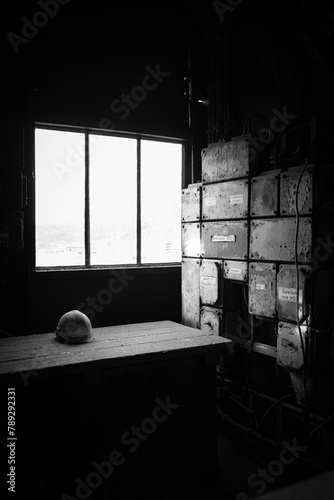 hard hat by the window in an abandoned factory, dramatic photo