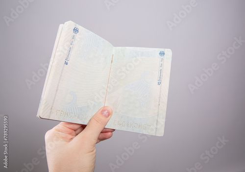 Close up of a female hand holding an open German passport photo