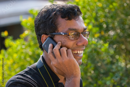 South asian young man talking on a cell phone