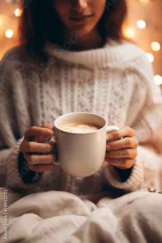 woman in soft knitwear, enjoying a mug of hot cocoa in a cozy setting сreated with Generative Ai
