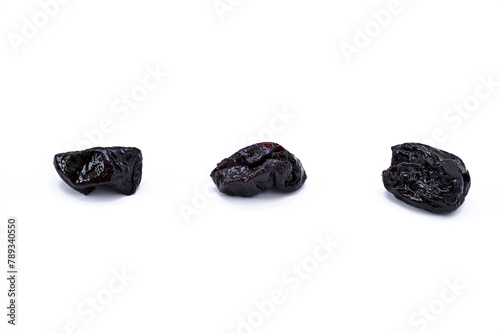 three dried prunes isolated on white background